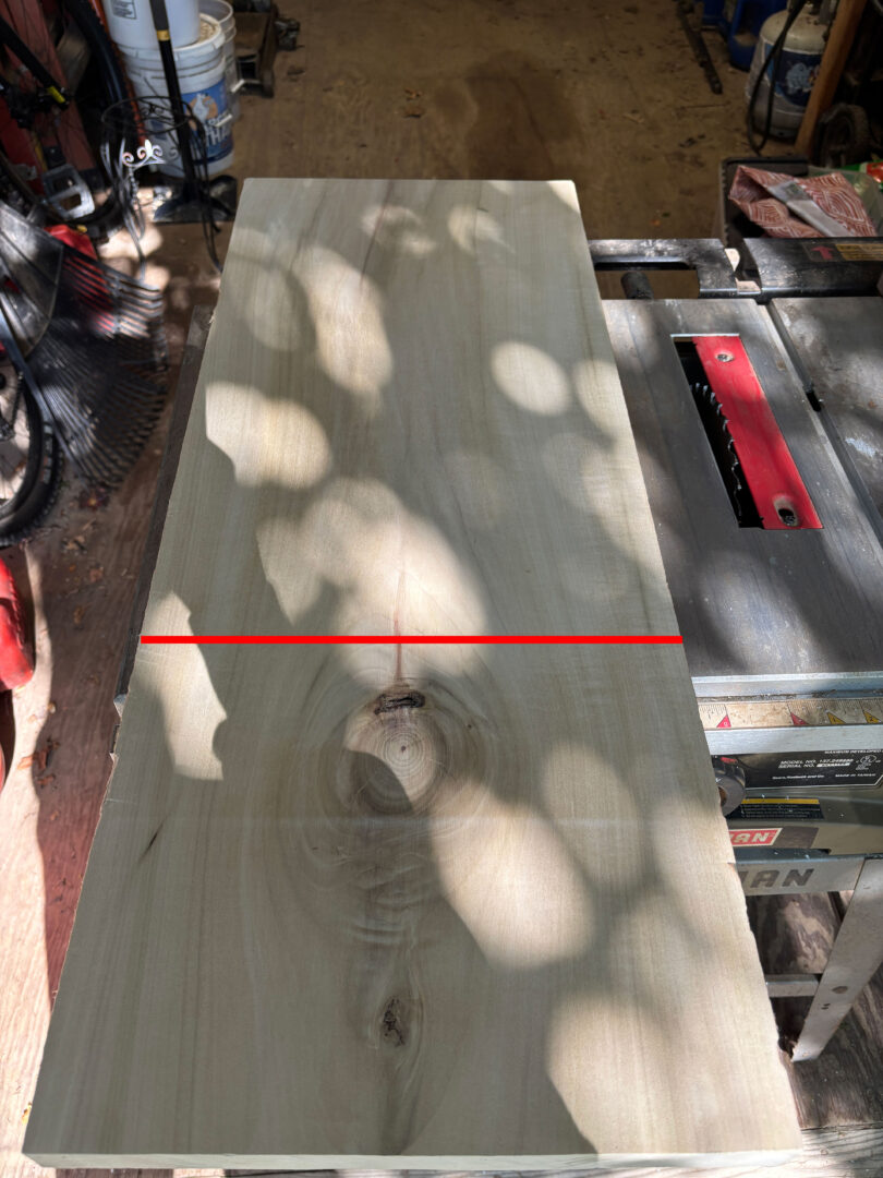 Flat sawn Poplar board with red line drawn across
